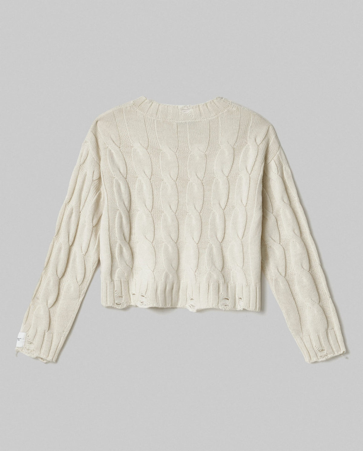 maglia paricollo corta con trecce e rotture bianco burro hinnominate 